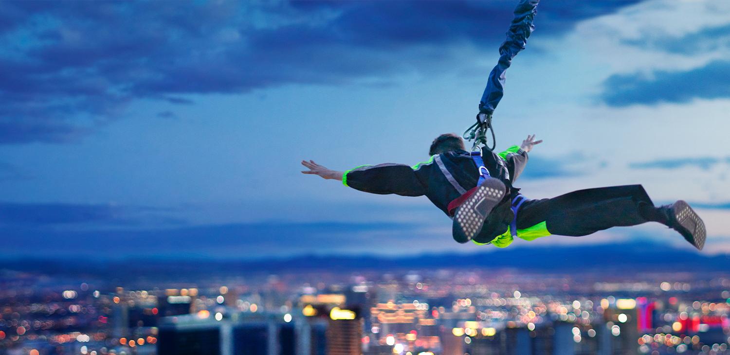 Man taking leap from SkyJump with view of Vegas