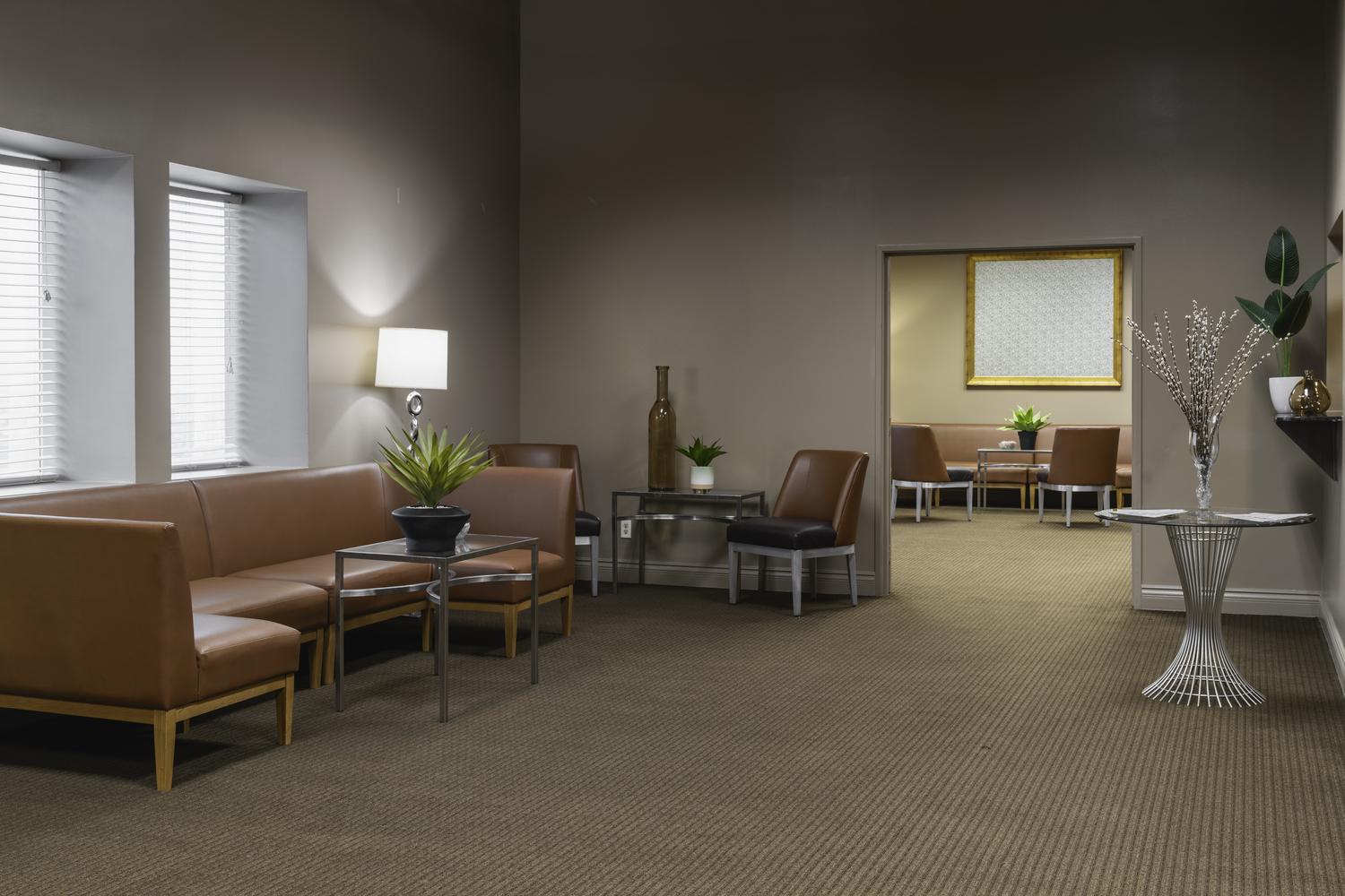 A side room with couch outside of the main meeting room