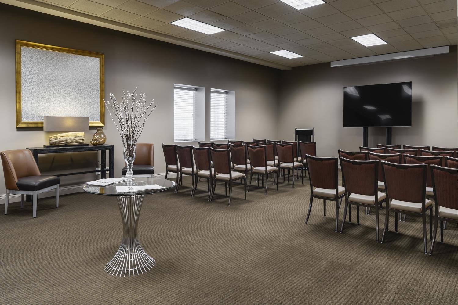 meeting room with a TV at the front and rows of chairs facing the TV