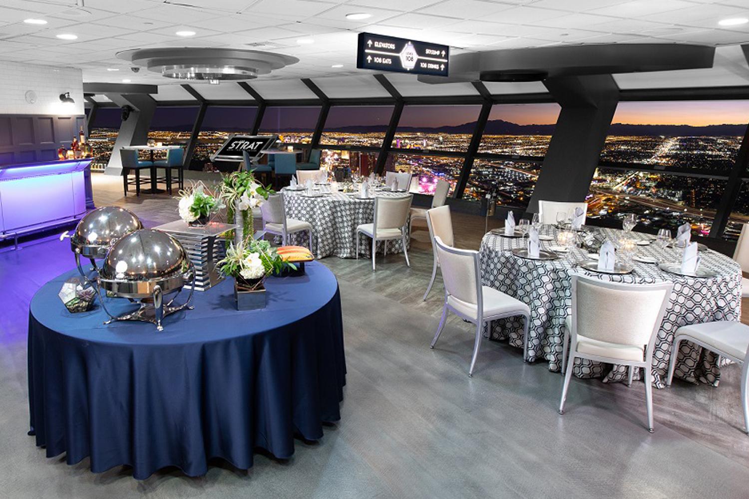 The STRAT SkyPod Level 108 tables set up with tablecloths with view of the Las Vegas Strip