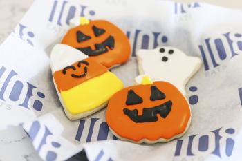 Halloween shaped cookies, a ghost, pumpkin and candy corn on 108 Eats tissue paper
